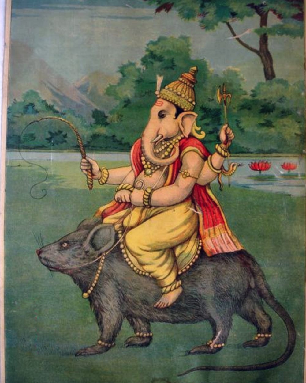 Ganesha in a yellow dhoti and jewelled crown riding his mouse across a green landscape, an axe and a sweet in his hands — a bazaar print of 1910.