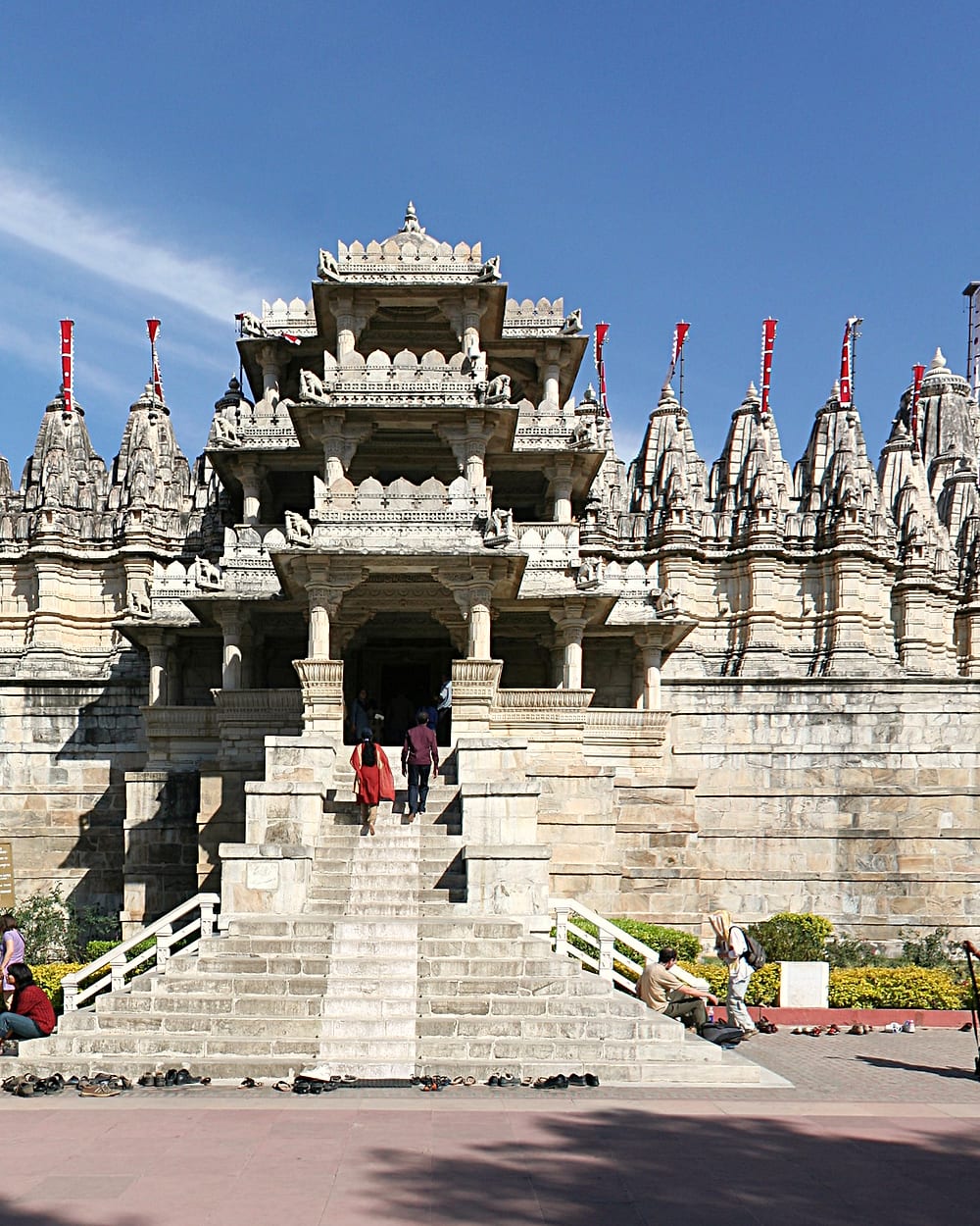 The white marble spires of the Ranakpur Jain temple rising against a clear blue sky.