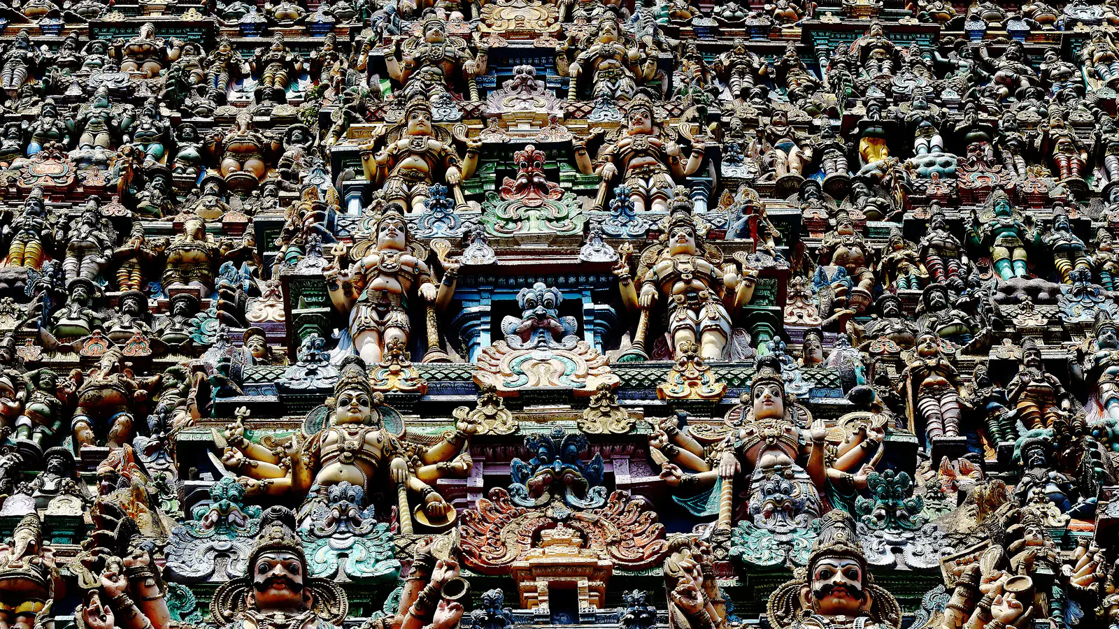 Hundreds of painted stucco figures of gods, goddesses and attendants covering a temple gateway tower