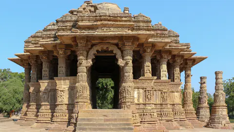 The carved sandstone assembly hall of the Modhera Sun Temple under a clear sky
